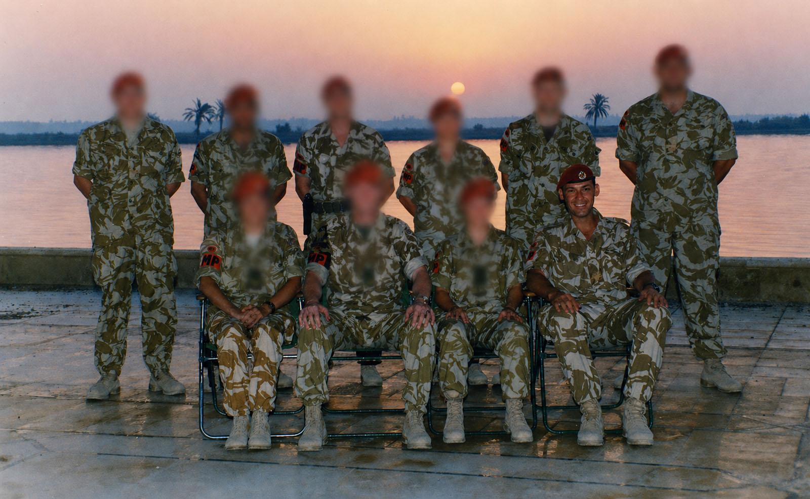 Royal Military Police team photo at sunset, Basra, Iraq. Faces of colleagues obscured for privacy.